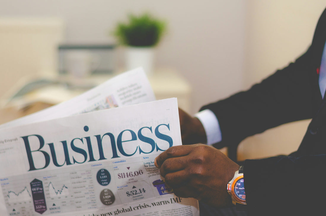 business man reading analytics newspaper