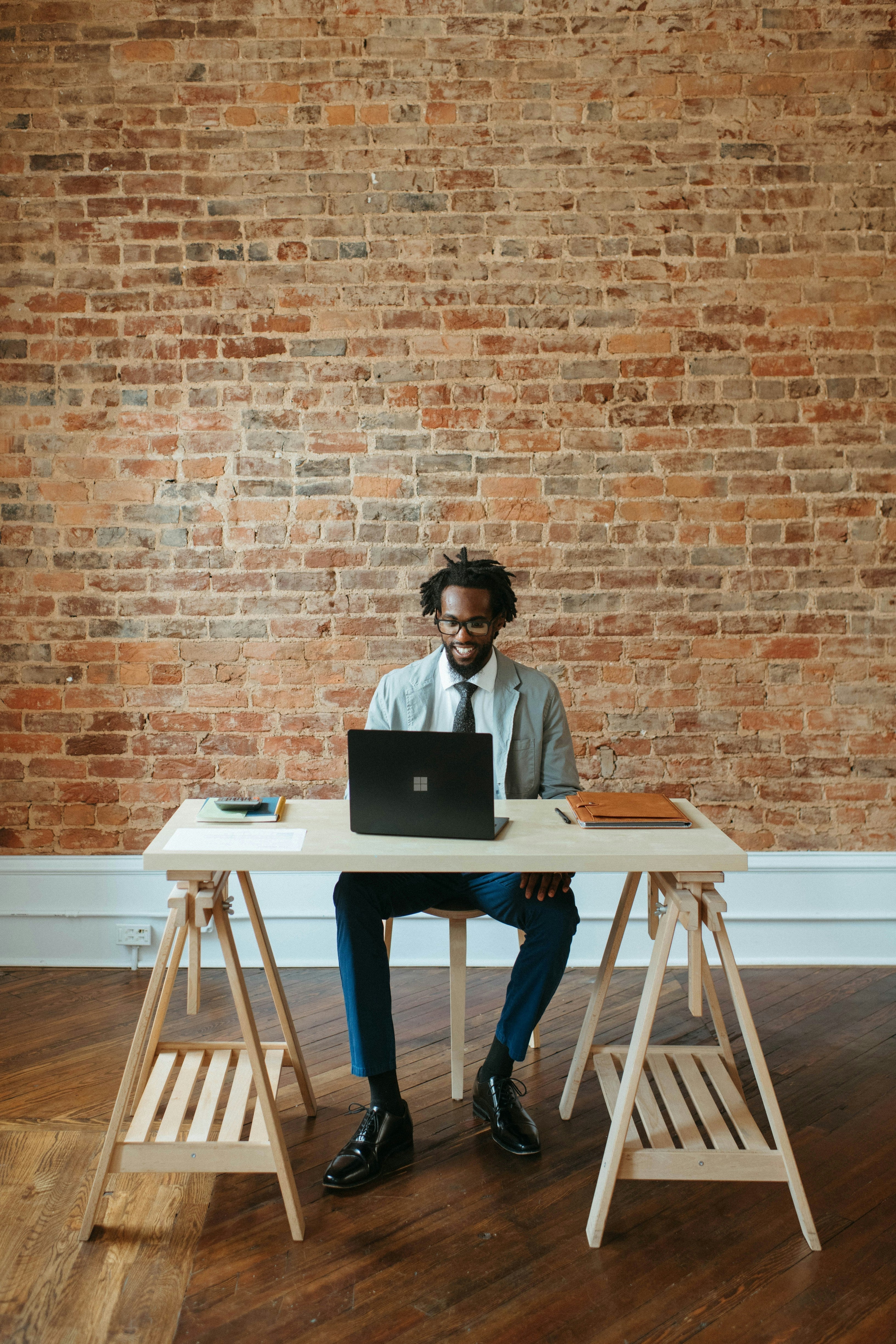 business owner at a desk and laptop